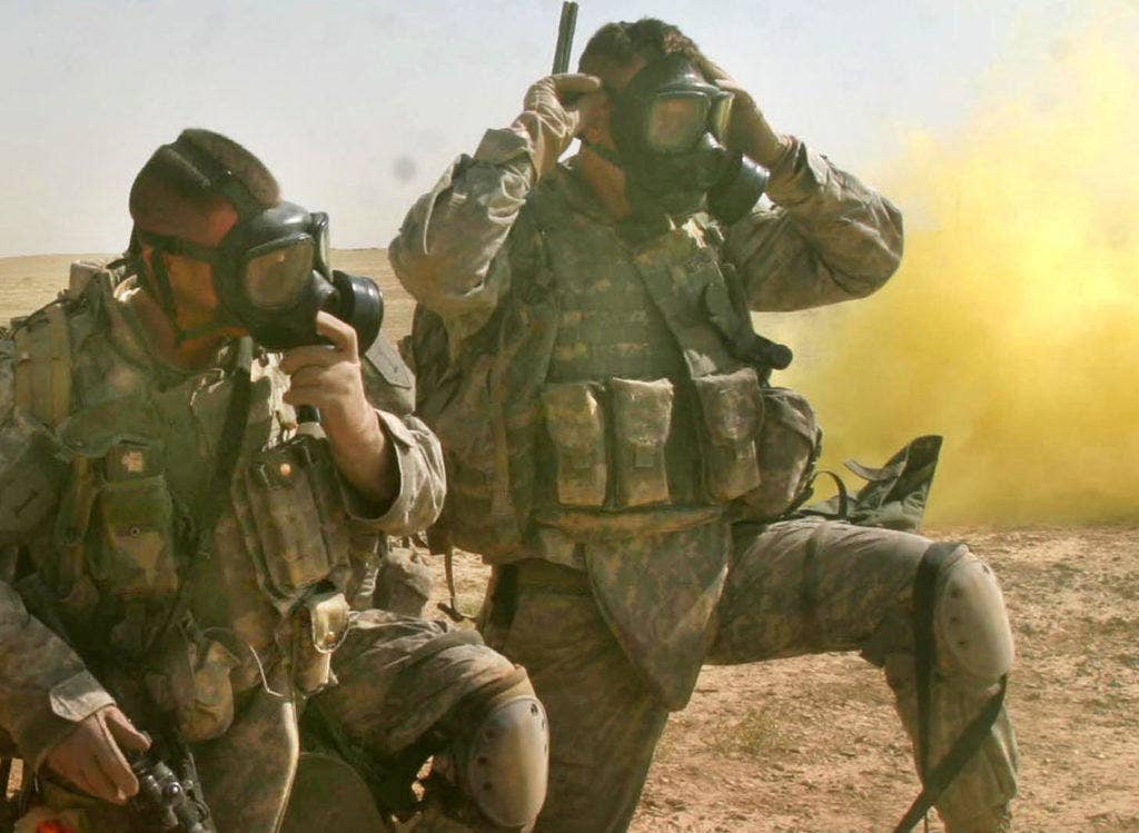 U.S. Army Soldiers put their gas masks on for a simulated chemical attack during a training mission near Camp Ramadi, Iraq, Sept. 25, 2007. (U.S. Marine Corps photo by Sgt. Andrew D. Pendracki)