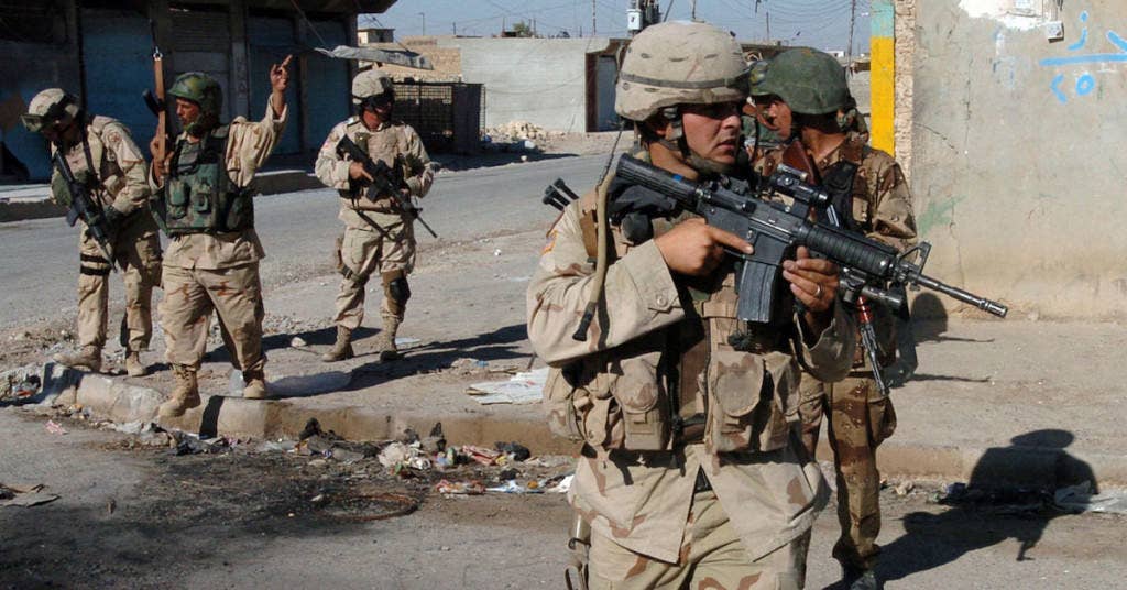 U.S. Army and Iraqi soldiers cross an intersection during a routine security patrol in downtown Tal Afar, Iraq | US Navy photo