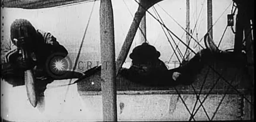 A German pilot prepares to drop a mortar round on a target. This was what passed for bombing in the early days of World War I. (Youtube screenshot)