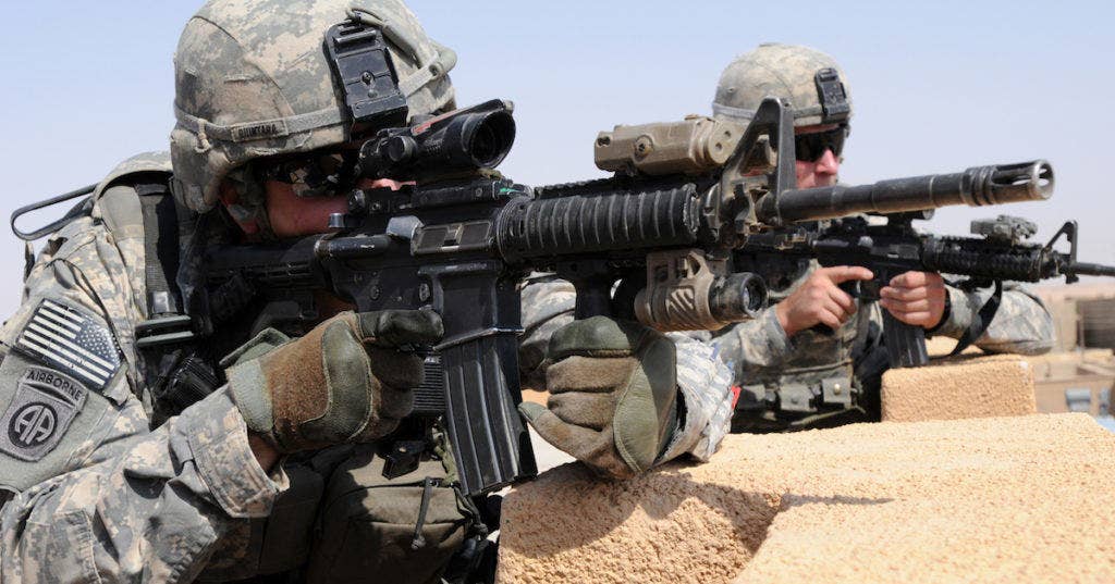 U.S. Army 1st Lt. Branden Quintana, left, and Sgt. Cory Ballentine pull security with an M4 carbines on the roof of an Iraqi police station in Habaniyah, Anbar province, Iraq, July 13, 2011. Ballentine is a forward observer and Quintana is a platoon leader, both with Bravo Company, 2nd Battalion, 325th Airborne Infantry Regiment, 2nd Advise and Assist Brigade, 82nd Airborne Division. (U.S. Army photo by Spc. Kissta Feldner/Released)