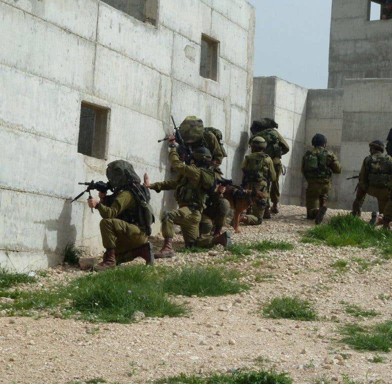 Officers with the Kfir Brigade practice fighting in built-up areas. (IDF photo)