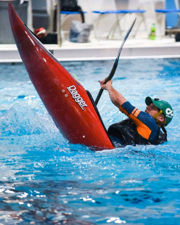A kayak football player speedily turns his kayak during one of the kayak football games in the tournament held at Naval Support Activity Bethesda's Fitness Center pool March 12. (U.S. Navy photo by Mass Communications Specialist 2nd Class Hank Gettys/released)