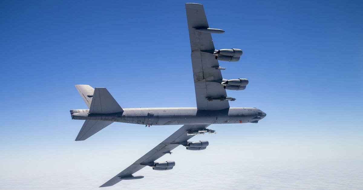 A B-52 Stratofortress assigned to the 419th Flight Test Squadron flies with eight PDU-5/B leaflet bombs connected to an external Heavy Stores Adapter Beam. USAF Christopher Okula.