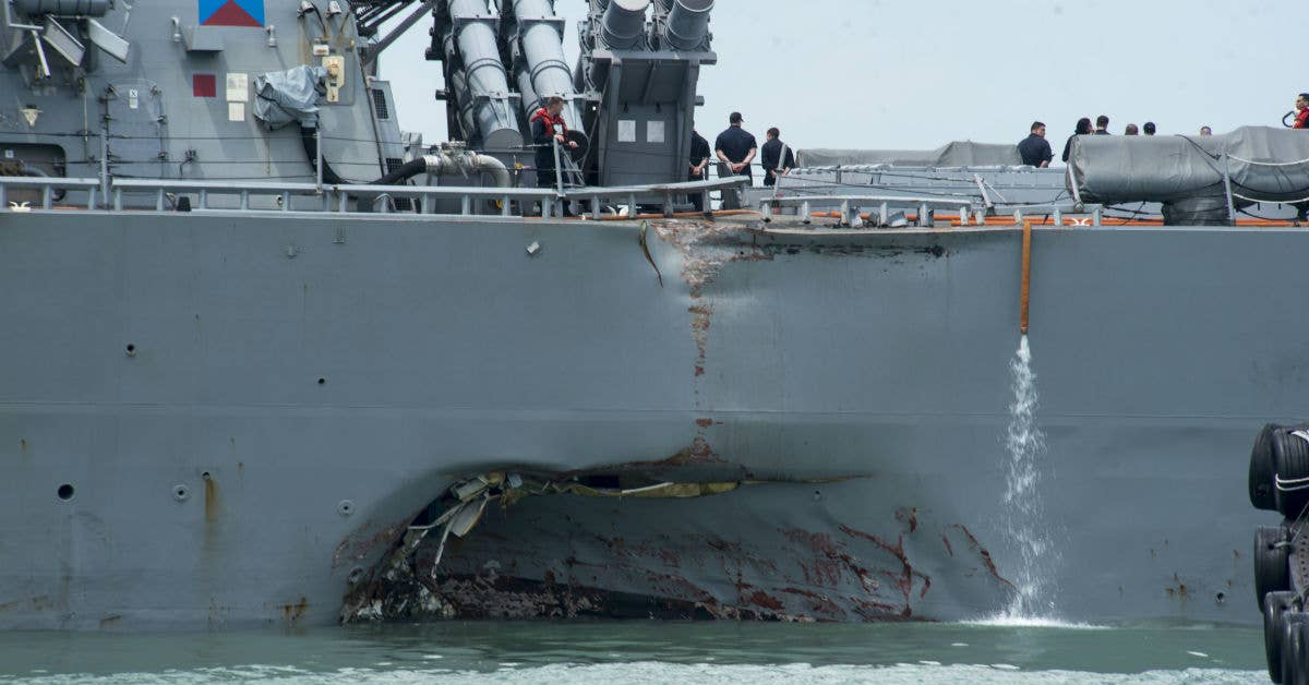 Damage to the portside is visible as the Guided-missile destroyer USS John S. McCain. Photo by US 7th Fleet Public Affairs.
