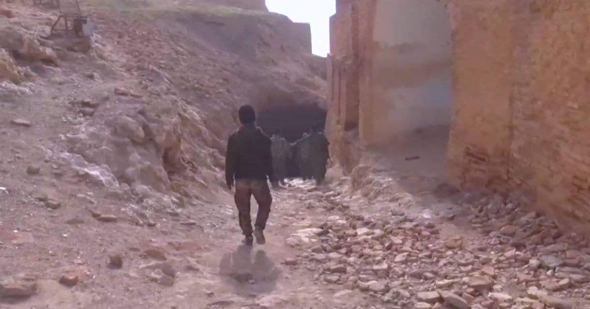 SDF fighters at the mouth of a tunnel used by ISIS at Jabar Castle. (Photo from Voice of America.)