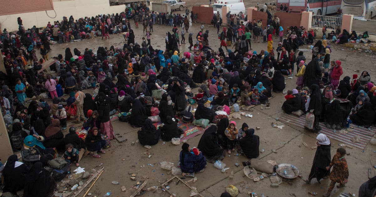 Women and children wait at a processing station for internally displaced people prior to boarding buses to refugee camps near Mosul, Iraq, Mar. 03, 2017. Army photo by Staff Sgt. Alex Manne