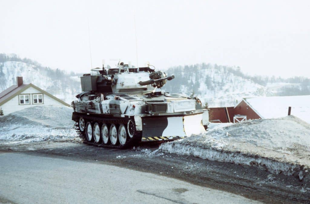 A British Scimitar reconnaissance vehicle is parked on a roadside during Operation COLD WINTER '87, a NATO-sponsored military exercise. (DOD photo)