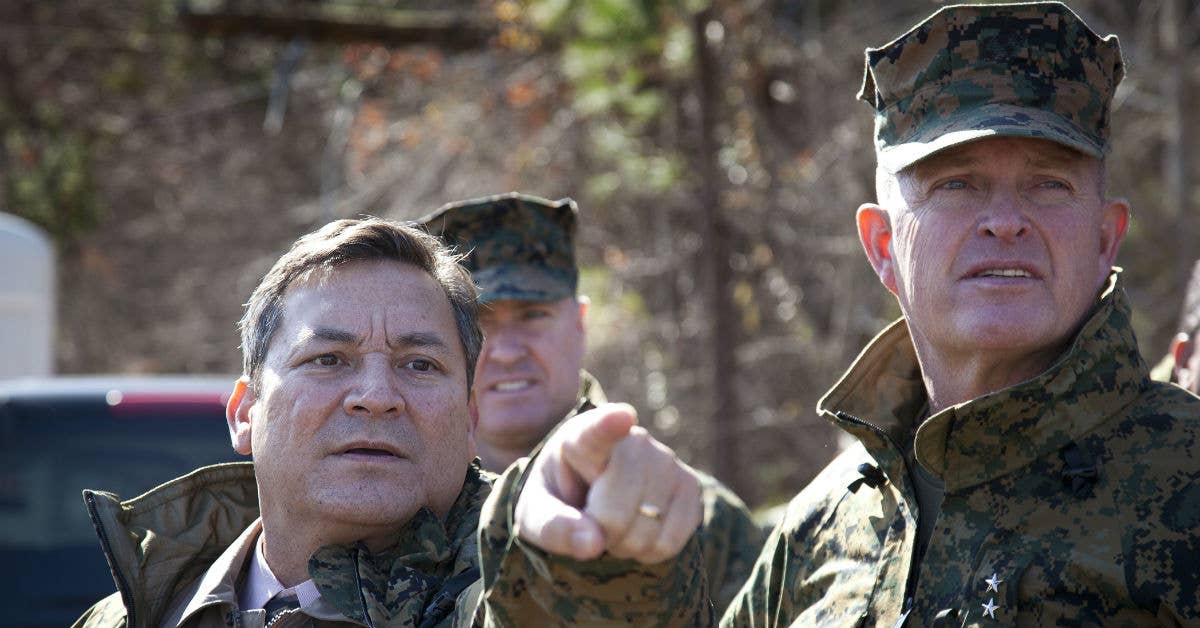 Gov. Eddie Baza Calvo (left) of Guam discusses range distance with Maj. Gen. Raymond Fox (right). (U.S. Marine Corps photo by Cpl. Scott Schmidt)