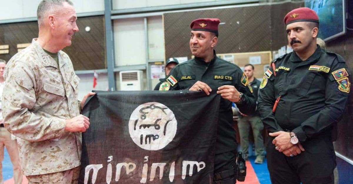 Members of the Iraqi Counter Terrorism Service present Gen. Joseph F. Dunford, a flag from Bartilah, a town recaptured by the Iraqi army just outside of Mosul from the Islamic State of Iraq and the Levant. Photo by Petty Officer 2nd Class Dominique Pineiro.