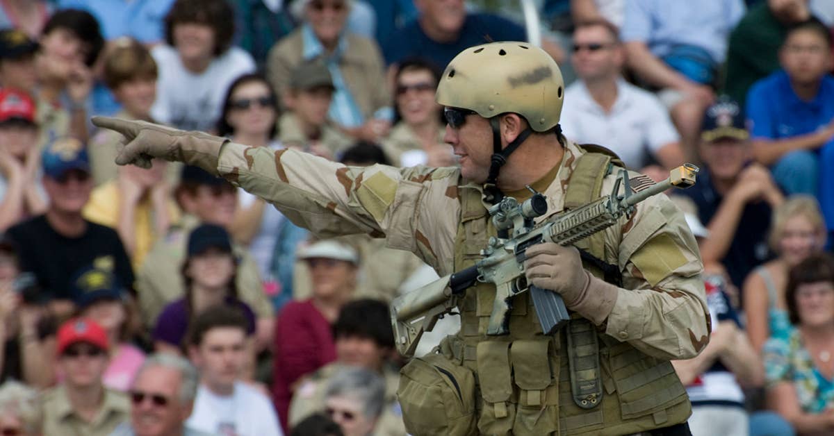 A Navy SEAL points to members of the crowd during a capabilities demonstration as part of the 2009 Veterans Day Ceremony and Muster XXIV at the National Navy UDT-SEAL Museum in Fort Pierce, Fla. The annual muster is held at the museum, which is located on the original training grounds of the Scouts and Raiders. Photo by Petty Officer 2nd Class Joseph M. Clark.