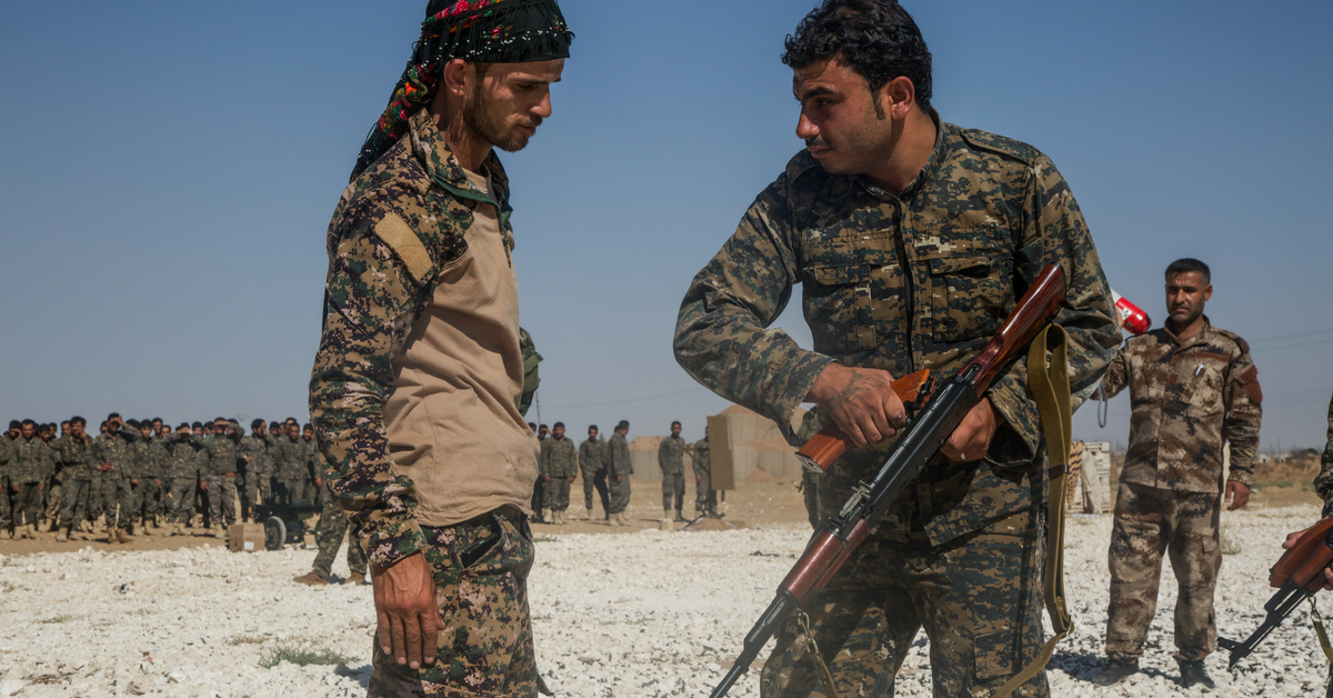 An instructor with the Syrian Democratic Forces observes a trainee clearing his rifle during small arms training in Northern Syria, July 31, 2017. Army photo by Sgt. Mitchell Ryan.