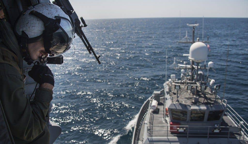 Naval Aircrewman (Helicopter) 2nd Class Corey Turner, assigned to Helicopter Sea Combat Squadron (HSC) 8, participates in a Helicopter Visit, Board, Search, and Seizure (HVBSS) training exercise with a Range Support Craft (RSC) 1 in the Pacific Ocean off the coast of San Diego, April 16, 2015. (U.S. Navy photo by Mass Communication Specialist 2nd Class Daniel M. Young)