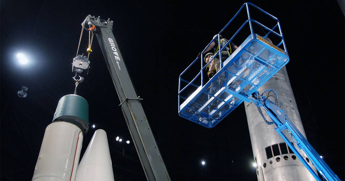 Restoration crews install the Minuteman IA missile in the Missile  Space Gallery at the National Museum of the USAF.