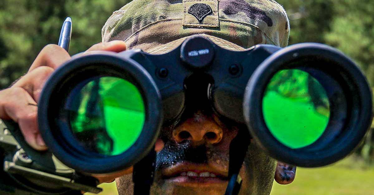 A US Army Soldier looks through binoculars as part of an orienteering event during the second day of the 2017 Forces Command Best Warrior Competition at Fort Bragg, N.C., Aug. 21, 2017. Army photo by Spc. Hubert D. Delany III