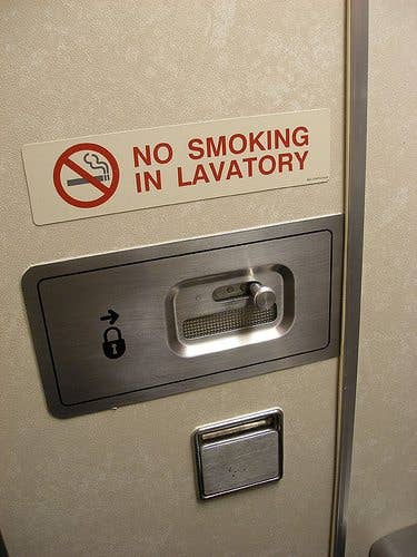Don't try it. Even if you tamper with the large smoke detector, there are more hidden through out the lavatory.