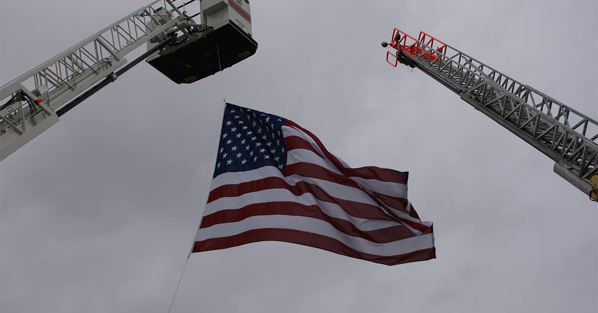 American Flag Hanging from Fire Truck Ladders. Photo from the City of Ludington.