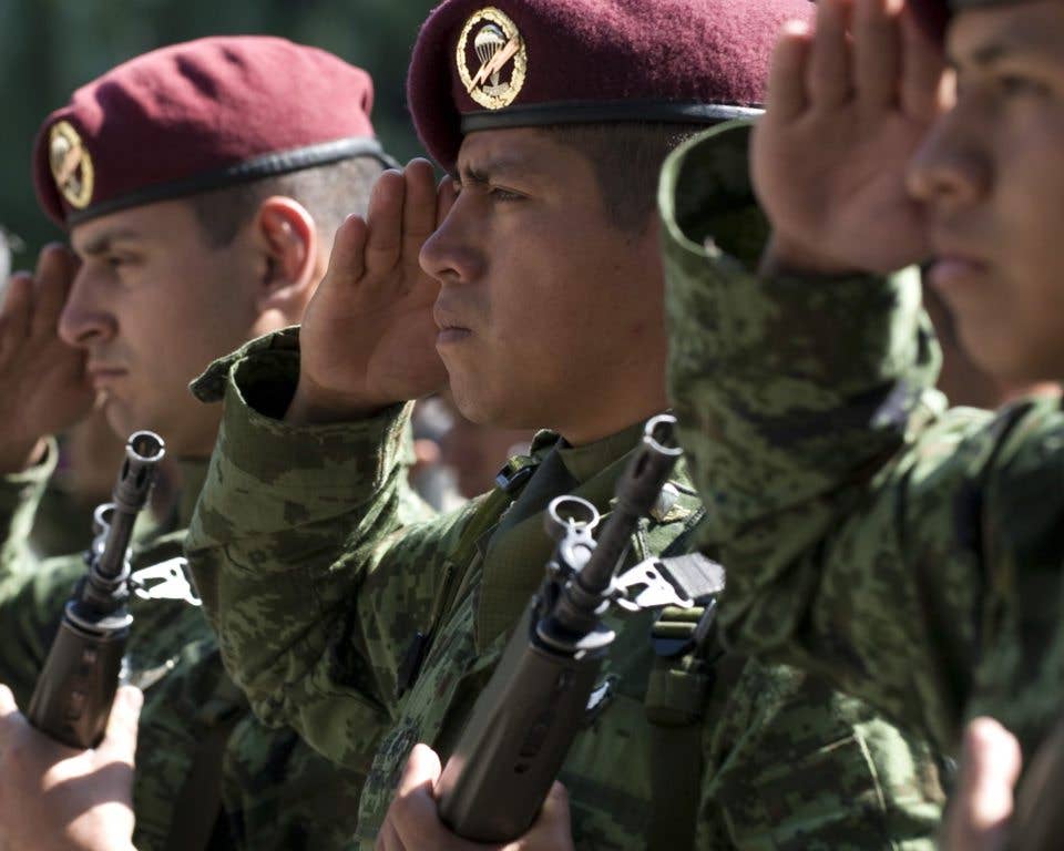 Mexican army members salute during a ceremony honoring the 201st Fighter Squadron at Chapultepec Park in Mexico City, Mexico, March 6, 2009. (DoD photo by Air Force Master Sgt. Adam M. Stump.)