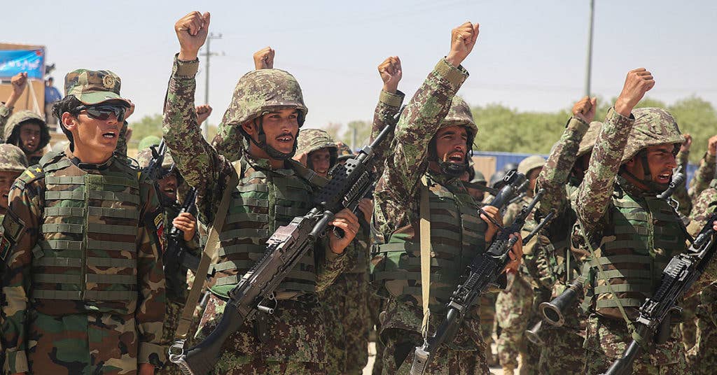 Afghan National Army soldiers with 2nd Kandak, 4th Brigade, 215th Corps chant their unit's battle song during a graduation ceremony at Camp Shorabak, Afghanistan, July 24, 2017. Hundreds of soldiers completed an operational readiness cycle at the Helmand Province Regional Military Training Center, an eight-week course designed to enhance its students' infantry and warfighting capabilities. (U.S. Marine Corps photo by Sgt. Lucas Hopkins)