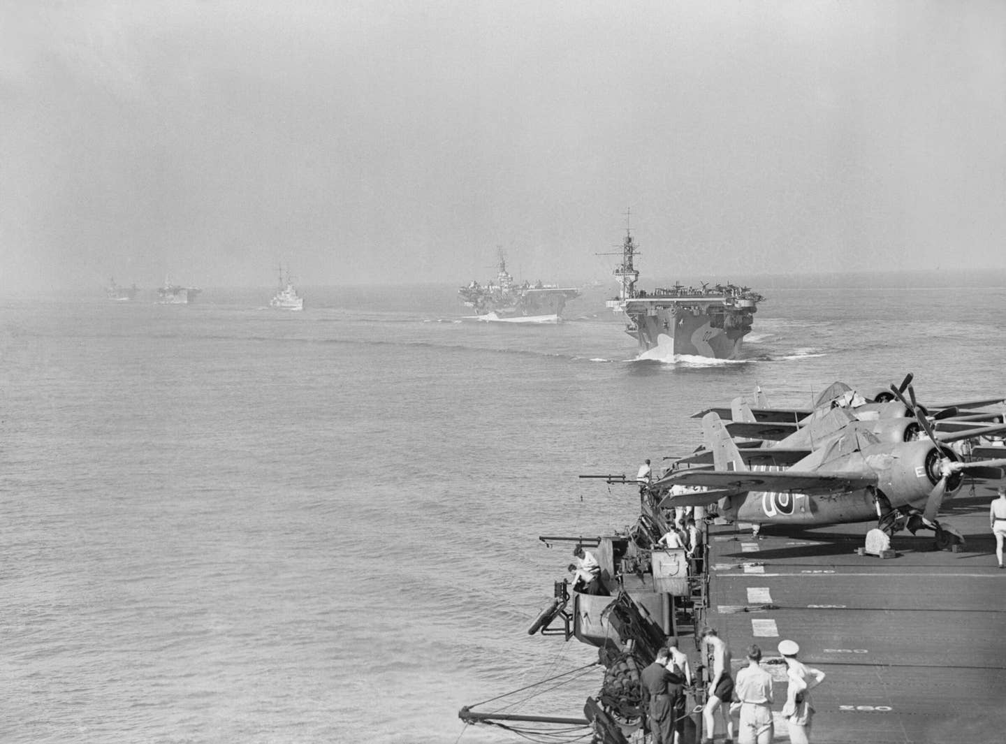 Scene from HMS Pursuer of other assault carriers in the force which took part in the landings in the south of France on Aug. 15, 1944. Leading are HMS Attacker and HMS Khedive. Three Grumman Wildcats can be seen parked on the edge of Pursuer's flight deck. (Royal Navy photo)