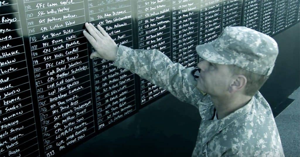 This soldier takes a moment to pay his respects. (Source: PBS/Screenshot)