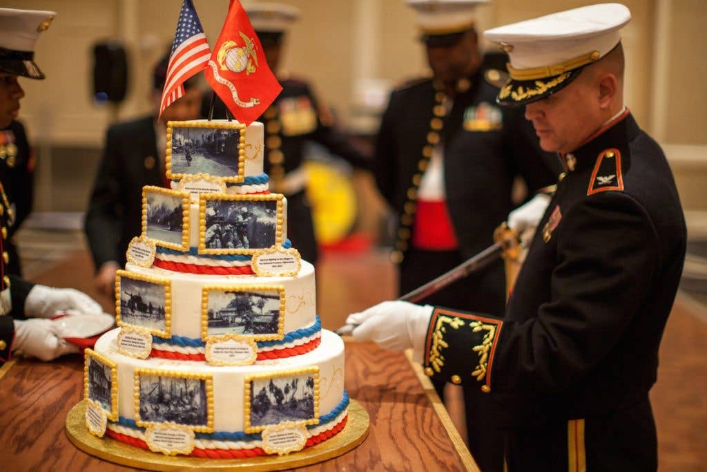 Col. Redifer cuts the birthday cake at the Marine Corps ball.