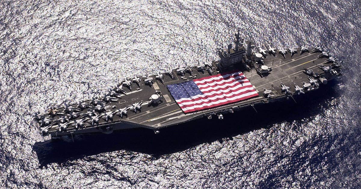 USS Nimitz (CVN 68) and Carrier Air Wing Eleven (CVW-11) personnel participate in a flag unfurling rehearsal on the ship's flight deck during Tiger Cruise with the help of fellow tigers. (Navy photo by Photographer's Mate 3rd Class Elizabeth Thompson)