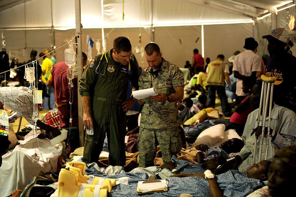 U.S. Air Force Colonel Len Profenna, left, chief of internal medicine, and Major Nathan Piovesan, a general surgeon from the 96th Medical Group, screen earthquake victims in the University of Miami medical tent Jan. 25, 2010, at the Toussaint Louverture International Airport in Port-au-Prince, Haiti. The doctors are screening 27 patients to be medically evacuated to the United States following a 7-magnitude earthquake that hit the city on Jan. 12, 2010. (DoD photo by Master Sgt. Jeremy Lock, U.S. Air Force)