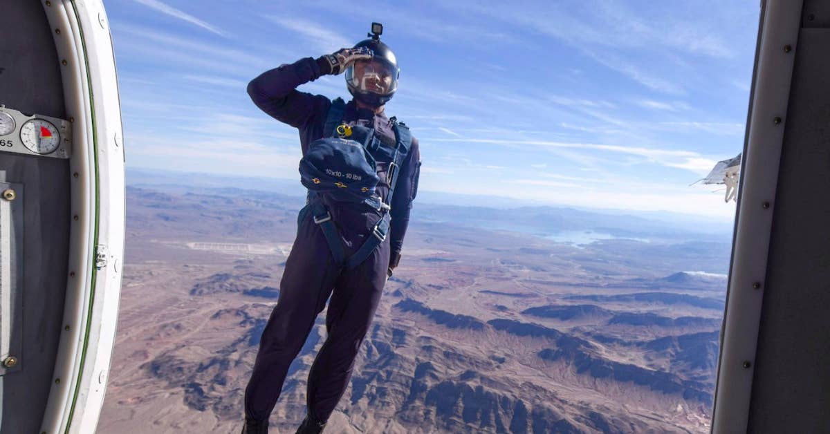 A member of the U.S. Air Force's Wing of Blue Parachute Demonstration Team jumps out of an aircraft over Nellis Air Force Base, Nev., Nov. 10 during the opening ceremony of Aviation Nation 2017 Nellis Air and Space Expo. (U.S. Air Force photo by Senior Airman Kevin Tanenbaum)