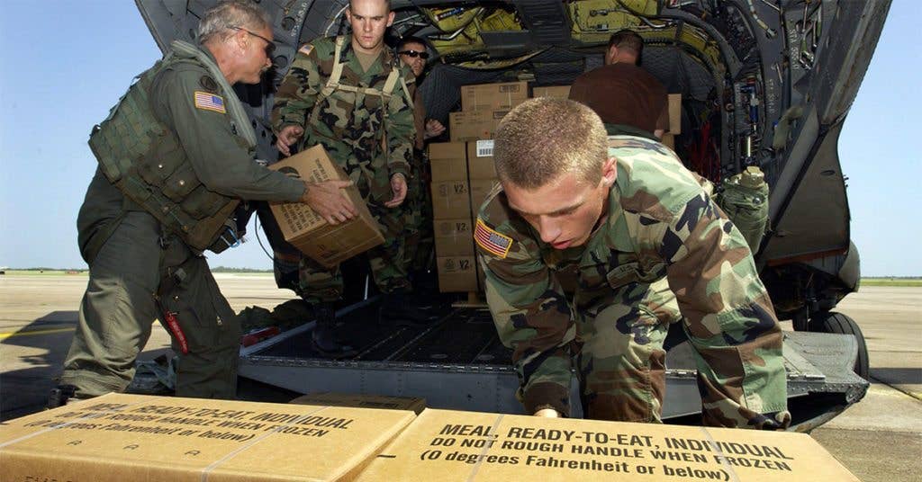 These soldiers load up an MRE supply to transport them to troops stationed on the ground.