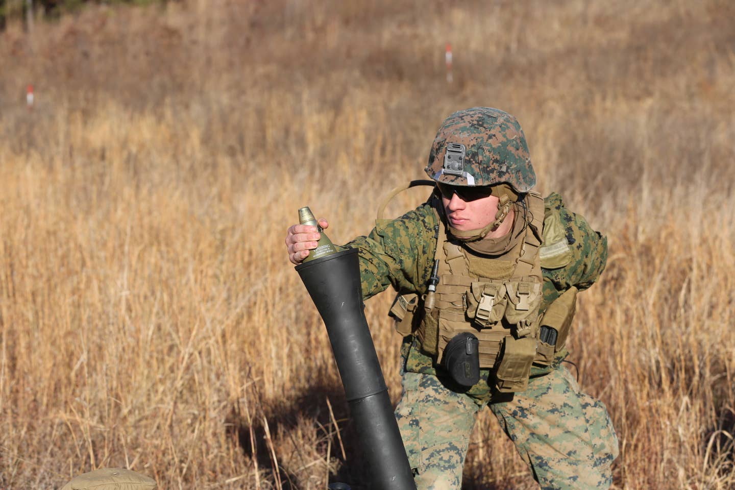 Lance Cpl. Joshua D. Fenton loads a round into an 81 mm Mortar during a deployment for training exercise at Fort. Pickett, Va., Dec. 11, 2016. (U.S. Marine Corps photo by Cpl. Shannon Kroening)