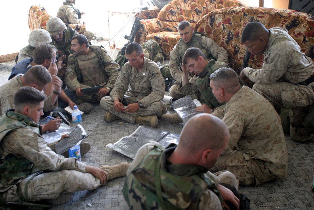 U.S. Marines, assigned to 1st Battalion, 8th Marines, 1st Marine Division, confirm map details about Fallujah, Iraq, before continuing patrols during Operation al Fajr (New Dawn) on Nov. 12, 2004. (DoD photo by Lance Cpl. Jonathan C. Knauth, U.S. Marine Corps.)