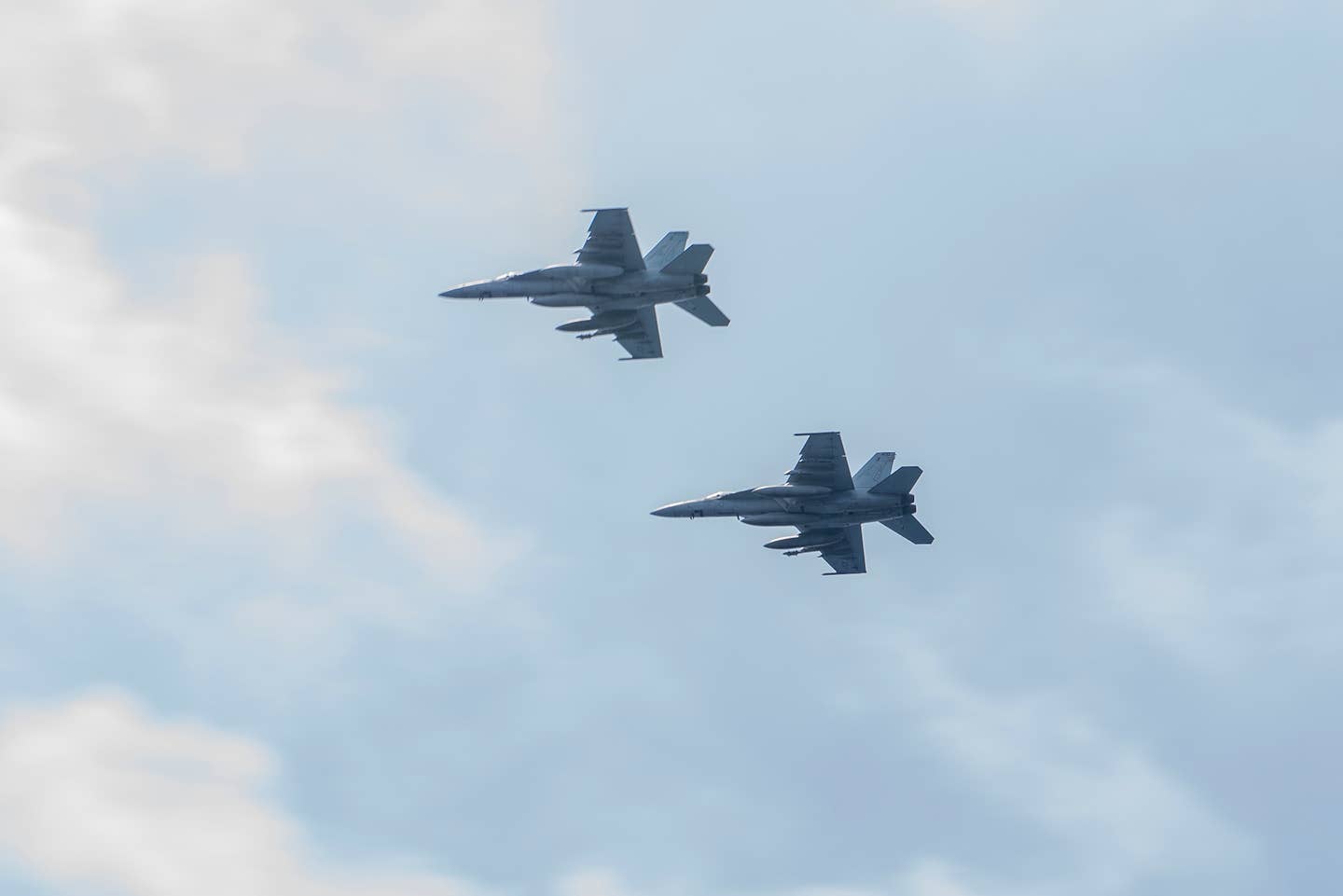 F/A-18E Super Hornets, assigned to the "Fist of the Fleet" of Strike Fighter Squadron (VFA) 25, fly over the flight deck of aircraft carrier USS Harry S. Truman (CVN 75). (U.S. Navy photo by Mass Communication Specialist 3rd Class Anthony Flynn/Released)