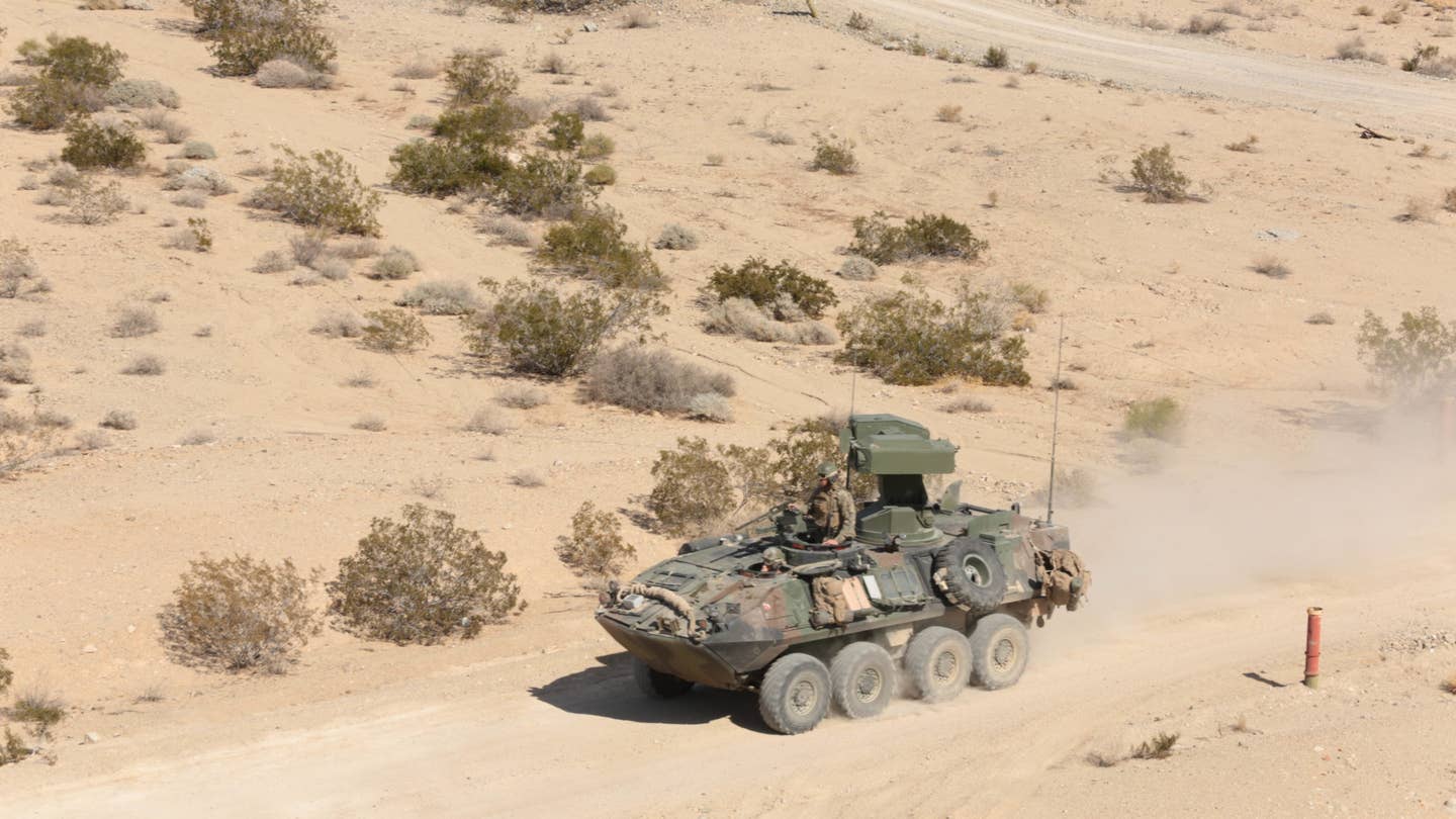 3rd Light Armored Reconnaissance Battalion Marines operate a Light-Armored Vehicle equipped with a new Anti-Tank weapons system to their next objective during testing at range 500 aboard the Combat Center, Feb. 16, 2015. The testing of the new system began Feb. 9 and is scheduled to end March 8. (Official Marine Corps photo by Lance Cpl. Medina Ayala-Lo)