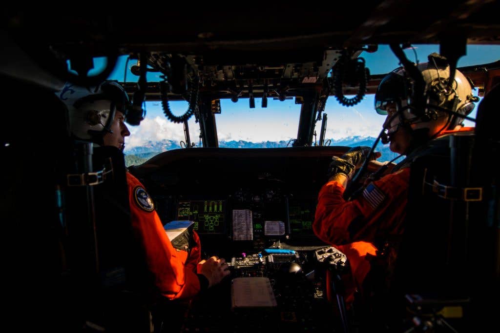 LT Chris Pitcher and Lt. Cmdr. Dillon Jackson assigned to Naval Air Station (NAS) Whidbey Search and Rescue review mission operations in an MH-60S Sea Hawk helicopter during a high altitude training evolution in the North Cascades National Park, Sept., 26, 2017. NAS Whidbey Island Search and Rescue's primary mission is to be the first responder for the aircraft and personnel stationed at NAS Whidbey Island. Secondary to that, they work closely with local agencies in order to be a responder to anyone in legitimate danger. ( U.S. Navy photo by Mass Communication Specialist 2nd Ignacio D. Perez)