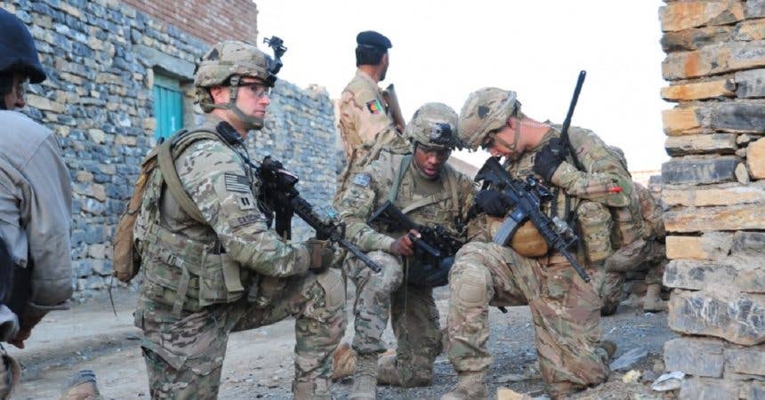 Capt. Lou Cascino, commander of Easy Company, 2nd Battalion, 506th Infantry Regiment, 4th Brigade Combat Team, 101st Airborne Division (Air Assault), pulls security while Staff Sgt. Eric Stephens and 1st Lt. James Kromhout verify their position during a partnered patrol in Madi Khel, Khowst Province, Afghanistan, Oct. 20, 2013. (U.S. Army Photo by Maj. Kamil Sztalkoper, 4th Brigade Combat Team, 101st Airborne Division)
