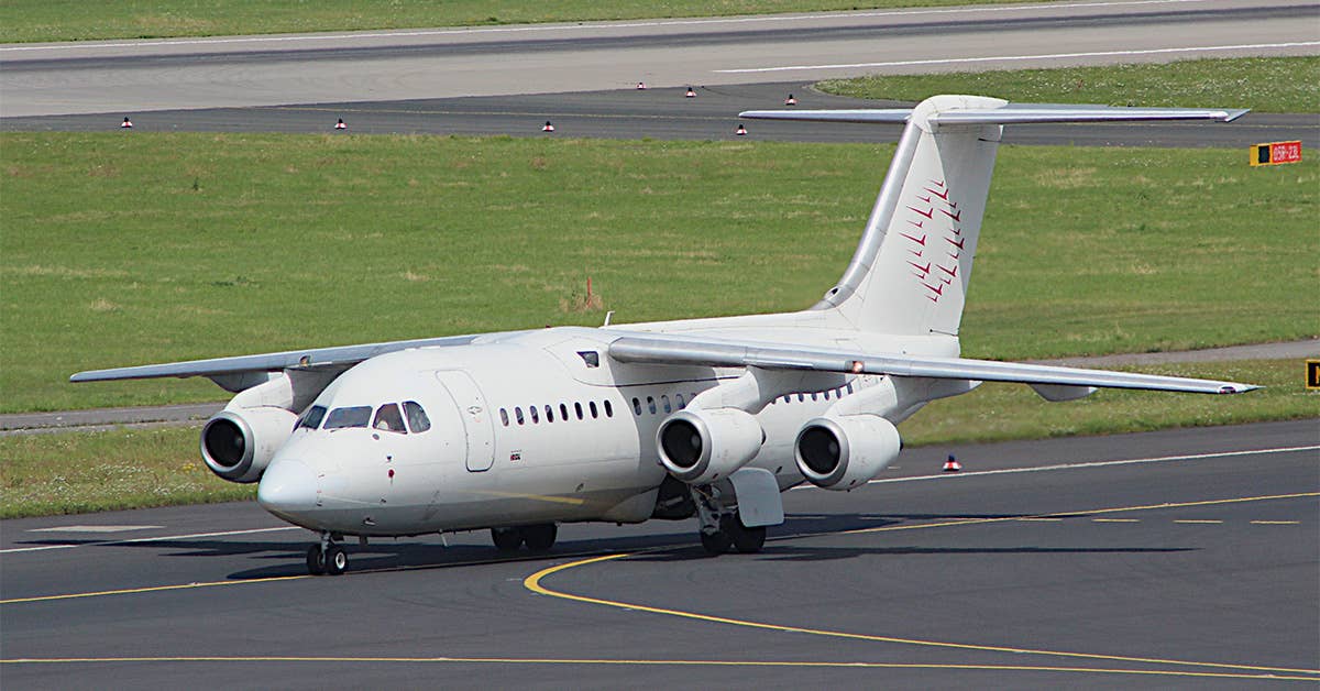 A BAe 146 four-engine regional jet sits on the runway. (Wikimedia Commons photo by user Lars Steffens)