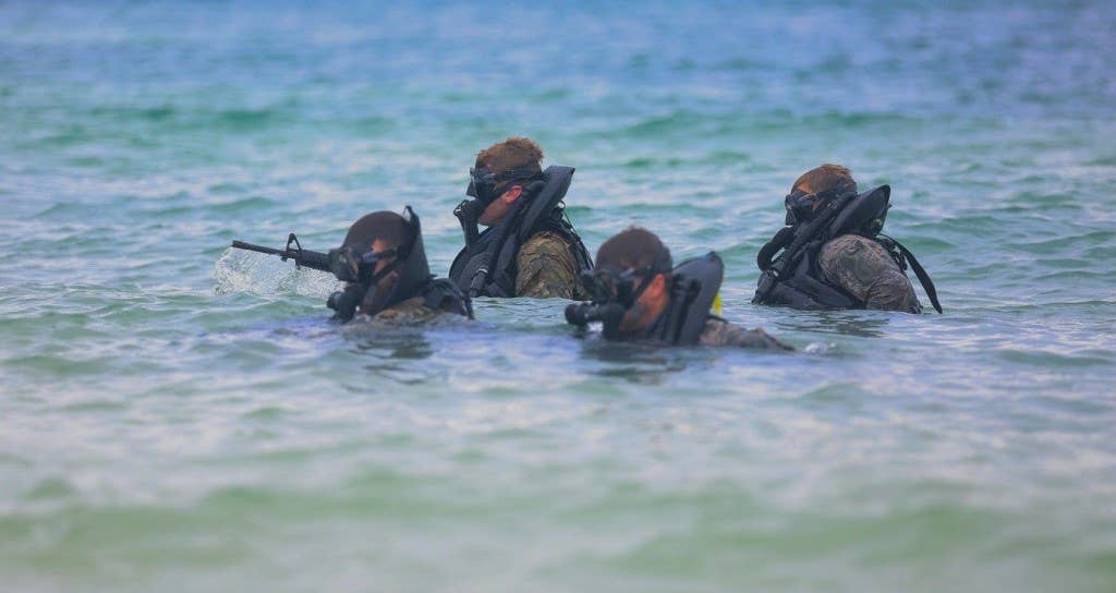 Green Berets, assigned to 3rd Special Forces Group-Airborne, exit the water during a beach infiltration training exercise, part of Combat Diver Requalification, in Key West, Fla., Jan. 20, 2016. (U.S. Army Photo)