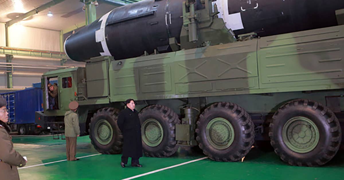 Kim Jong-un next to the newest and most powerful missile in the North Korean arsenal, Hwasong-15. (Photo from Rodong Sinmun)