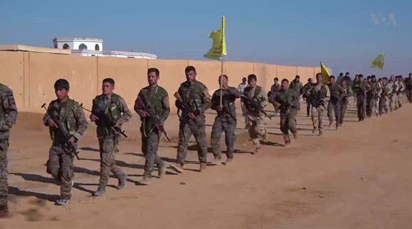 Syrian Democratic Forces march in Raqqa in 2016