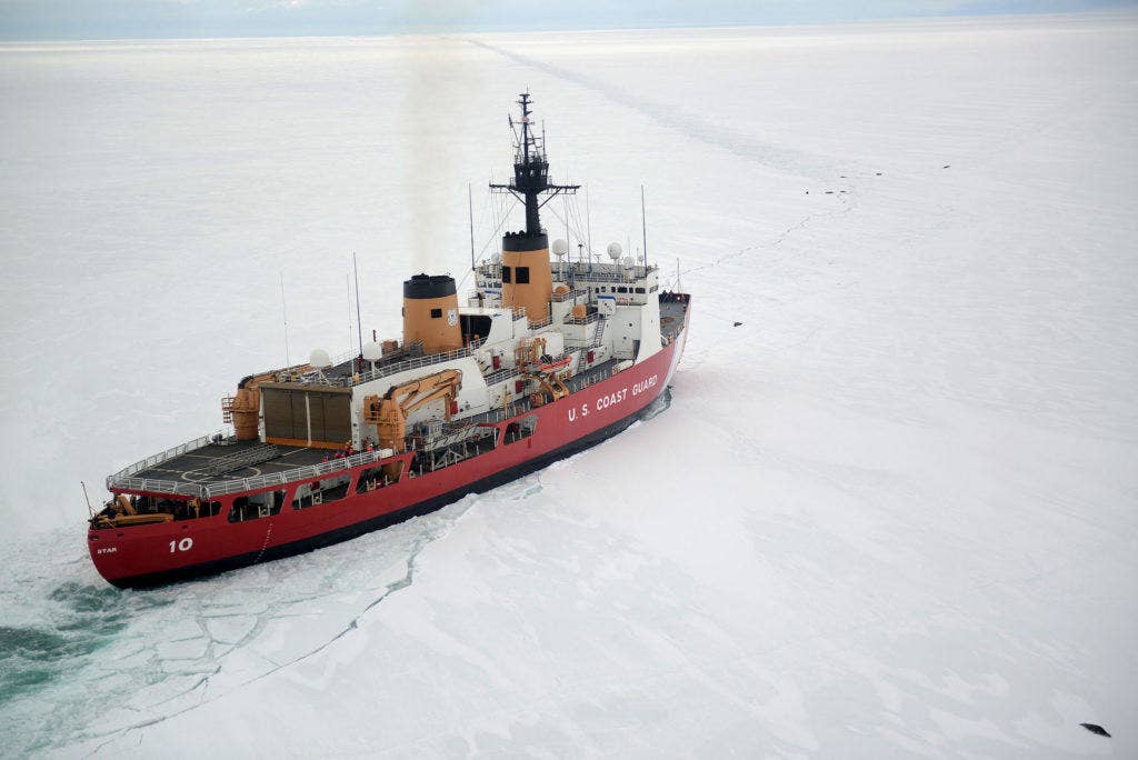 The Coast Guard Cutter Polar Star cuts through Antarctic ice in the Ross Sea near a large group of seals as the ship's crew creates a navigation channel for supply ships. (U.S. Coast Guard photo by Chief Petty Officer David Mosley)