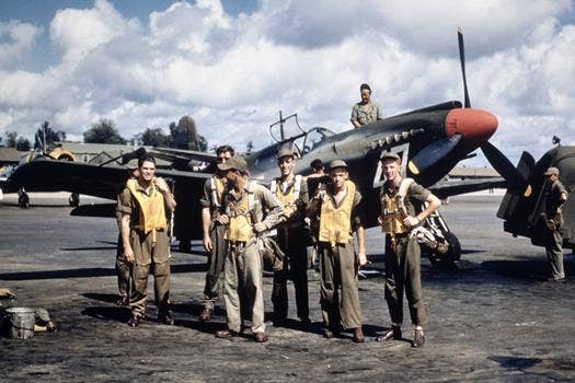 A-36 mustang dive bomber pilots standing in front of aircraft.