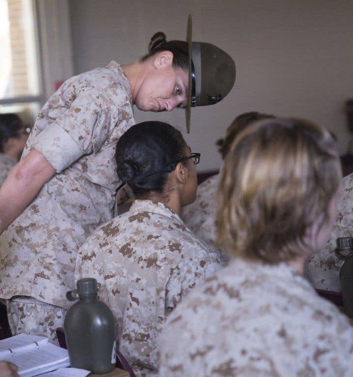 Staff Sgt. Maryssa Sexton, a chief drill instructor with November Company, 4th Recruit Training Battalion, ensures a recruit is paying attention during a history class Aug. 18, 2014, on Parris Island, S.C. (Photo by Lance Cpl. Vaniah Temple)