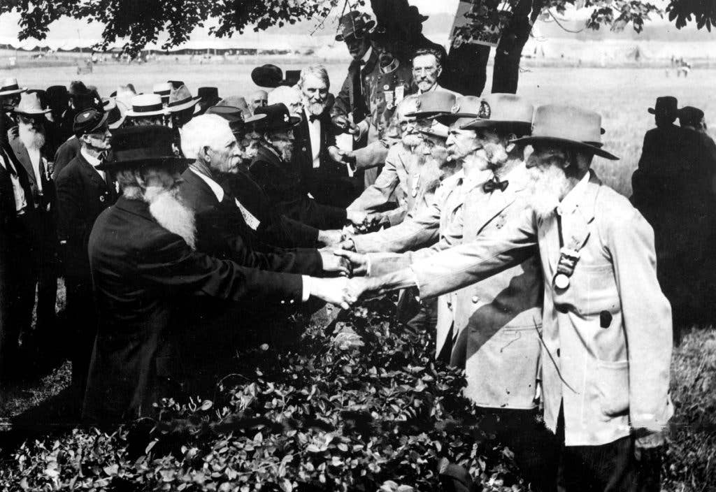 At the 50th anniversary of the battle of Gettysburg, Union (left) and Confederate (right) veterans shake hands at a reunion, in Gettysburg, Pennsylvania.