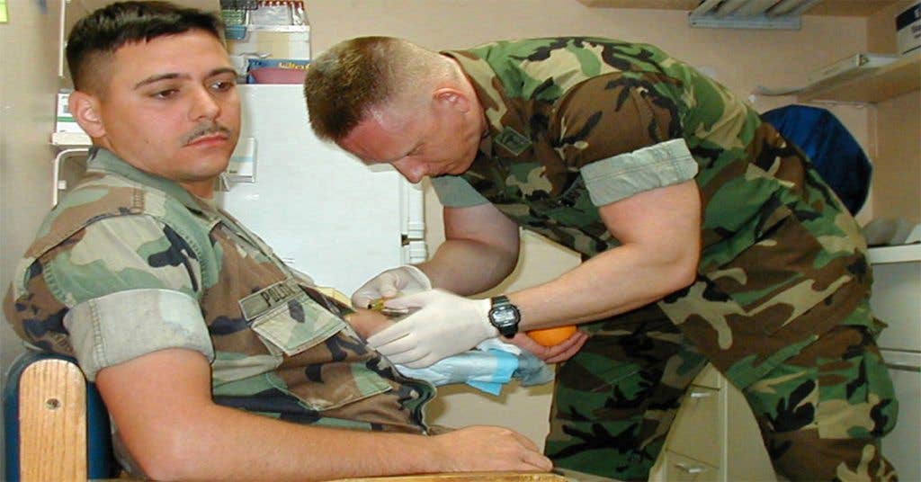 Hospital Corpsman 2nd Class Robert Blaasch draws blood from a patient as part of his duties as an Independent Duty Corpsman. (U.S. Navy photo by Photographer's Mate 2nd Class Amy Celentano.)