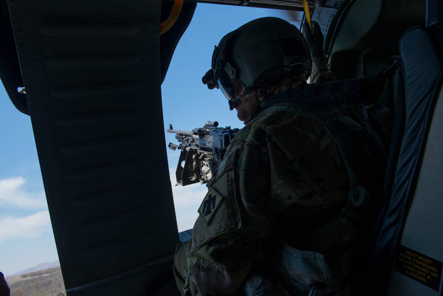 A door gunner on a UH-60 Black Hawk helicopter from the 244th Aviation Brigade, Oklahoma National Guard, scours the earth below during joint training at Falcon Bombing Range, Fort Sill, Okla., Mar. 22, 2017. (U.S. Air National Guard photo by Senior Master Sgt. Andrew M. LaMoreaux/Released)