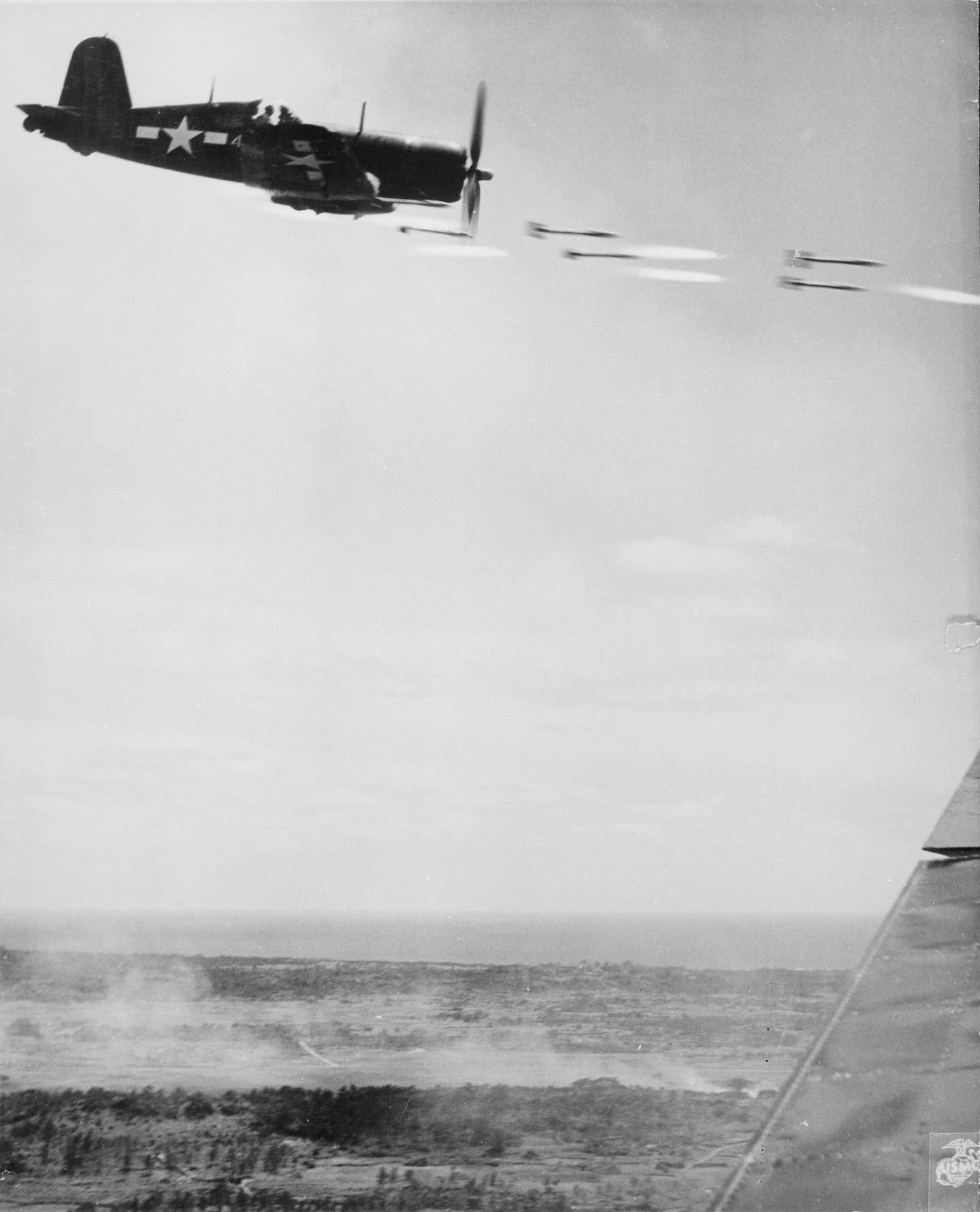 A Vought F4U Corsair fires rockets at ground targets on Okinawa. (DOD photo)