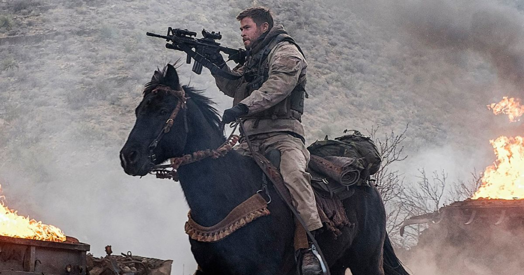 Chris Hemsworth plays Capt. Mitch Nelson as he rides into battle in 12 Strong. (Image courtesy of Warner Brothers)