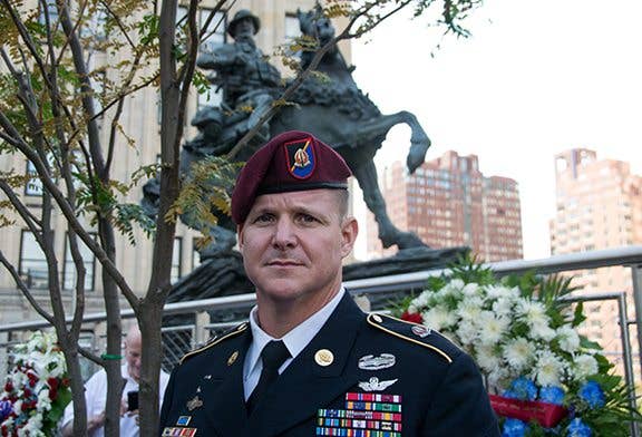 Command Sgt. Maj. Mark Baker of the 160th Special Operations Aviation Regiment (Airborne) poses in front of De Oppresso Liber, or the Horse Soldier, a 16-foot bronze statue honoring the work of Special Forces Soldiers in Afghanistan at the beginning of Operation Enduring Freedom in the last months of 2001. As a flight engineer on a 160th SOAR MH-47 Chinook, Baker helped transport the first Special Forces teams into Afghanistan through horrible weather and in some of the most challenging flying conditions in history. (U.S. Army Special Operations Command photo by Cheryle Rivas)