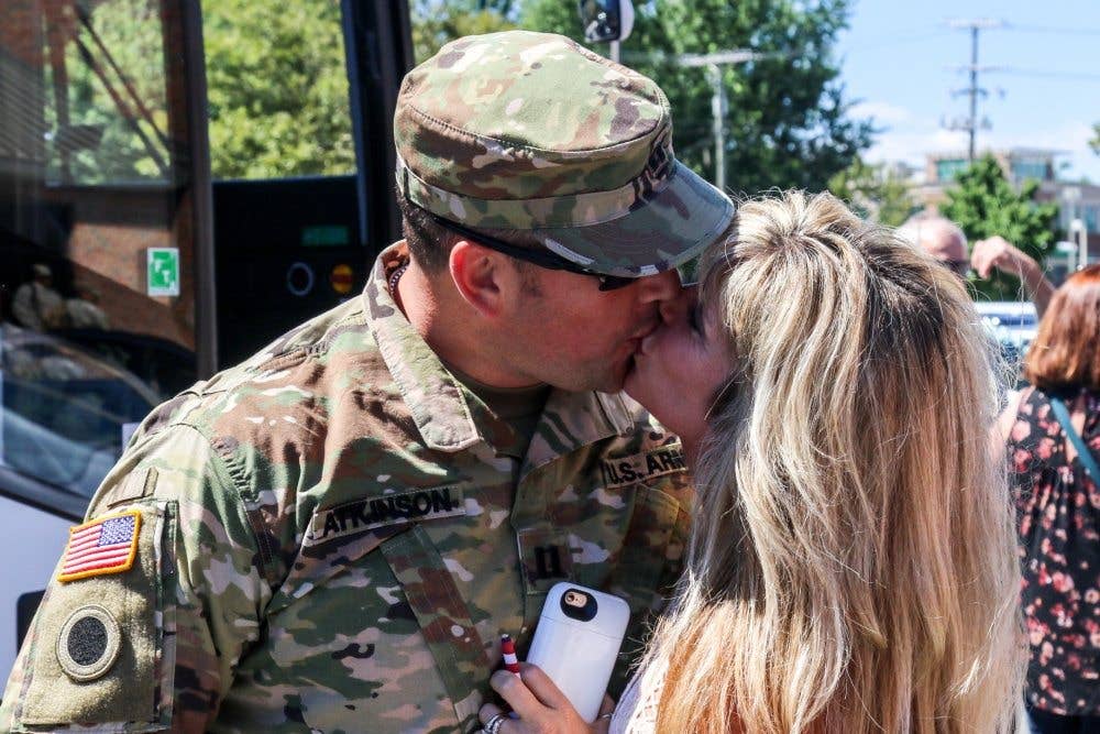 A spouse kisses her husband prior to a welcome-home ceremony. (Ohio National Guard photo by Staff Sgt. Michael Carden)