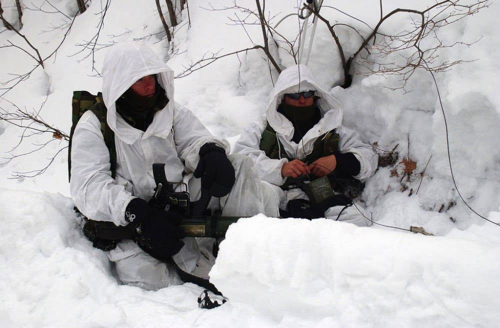 US Marine Corps (USMC) members with the 2nd Battalion, 3rd Marines, wait silently in the snow with a Shoulder-Launched Multipurpose Assault Weapon (SMAW) during a staged ambush for Japanese spectators on Camp Engaru, in support of Exercise FOREST LIGHT II 2003. (U.S. Marine Corps photo)
